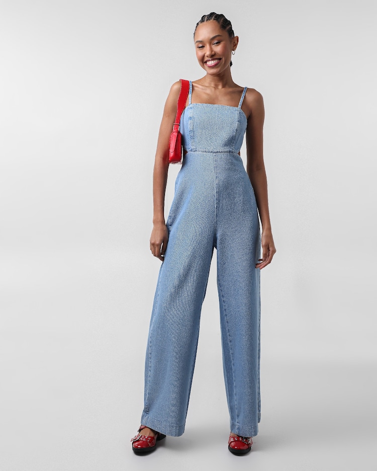 Riachuelo Macacão jeans com alça e recortes denim médio Azul