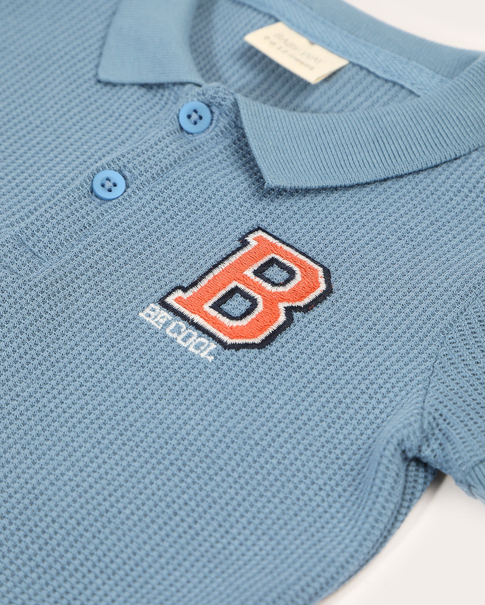 Camisa polo bebê manga curta pontilhada lettering azul