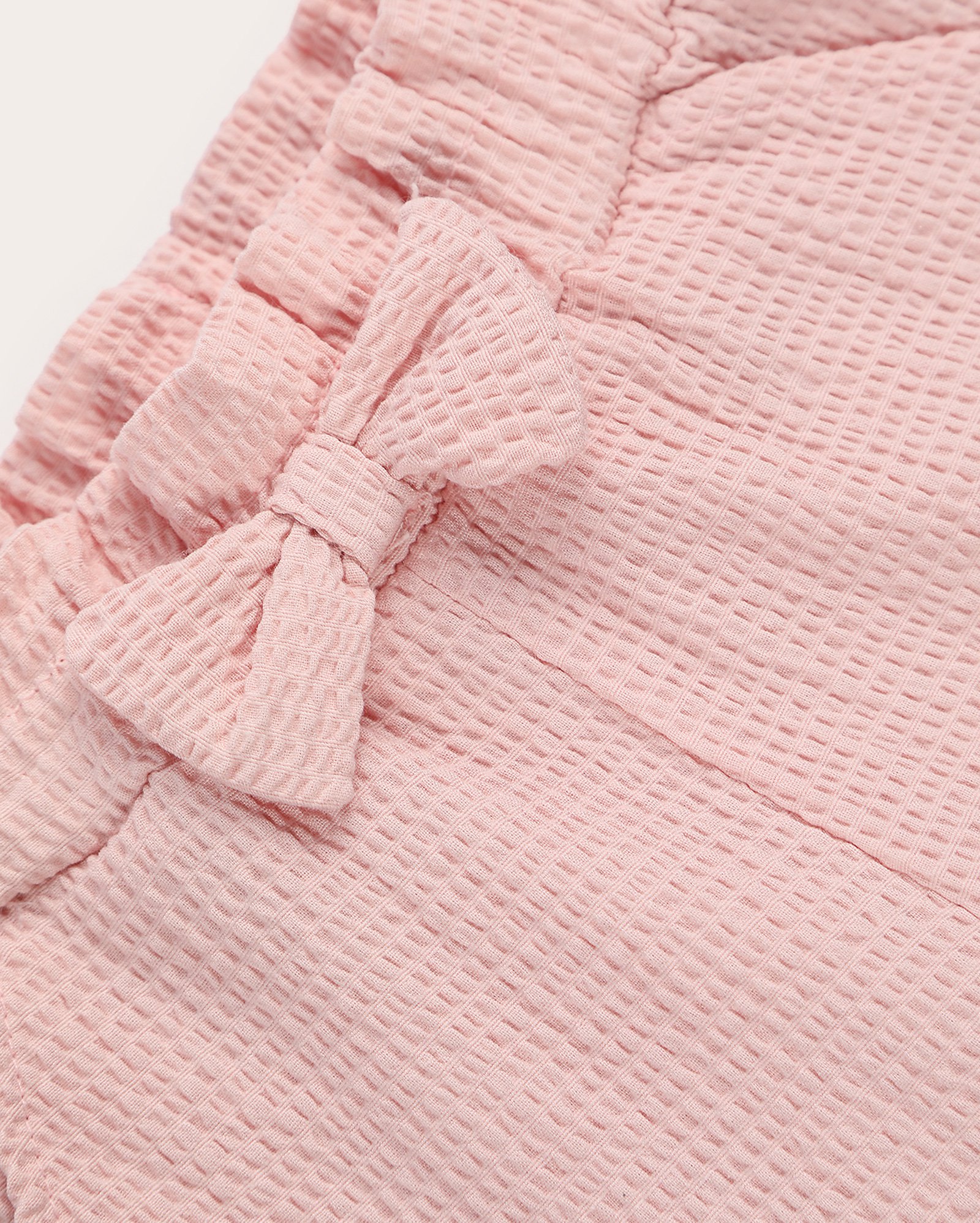 Calça baggy bebê texturizada com laço e cós de elástico rosa