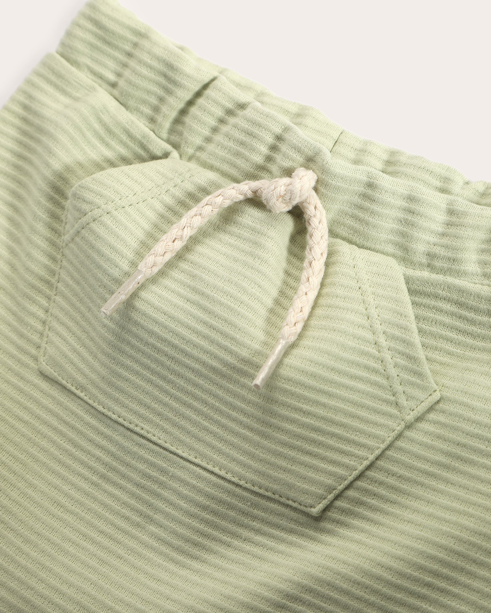 Short bebê em malha texturizada com bolso canguru verde