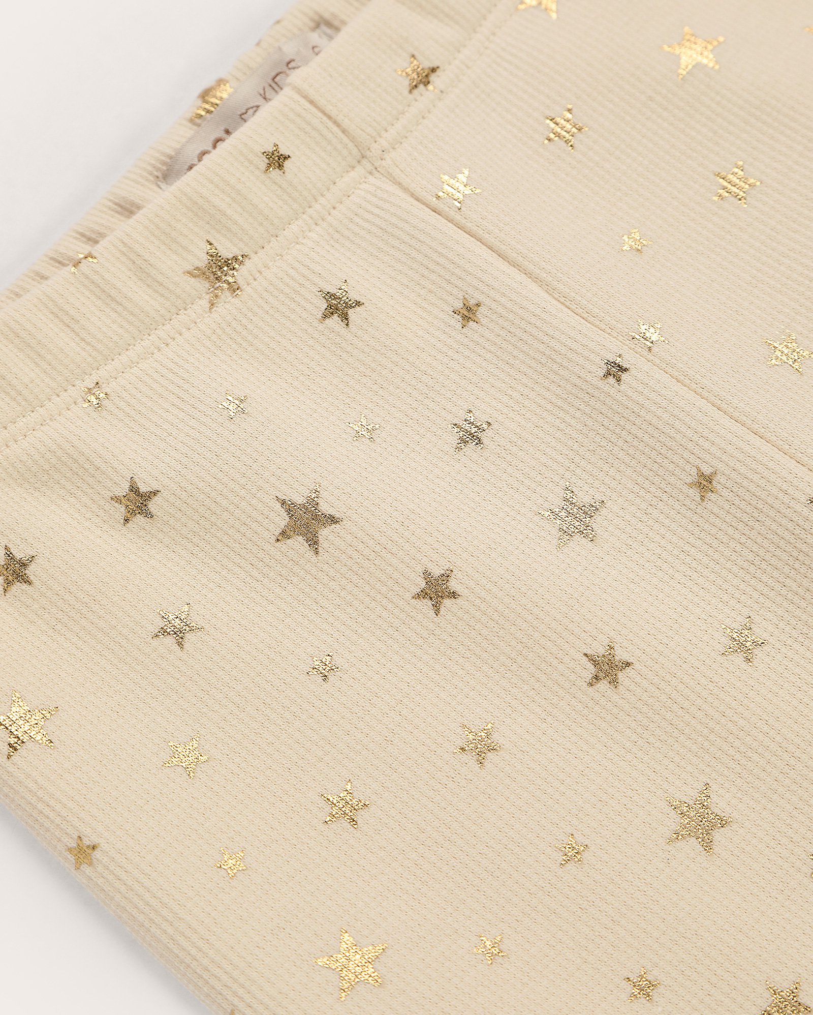 Calça legging infantil canelada estrela metalizada 4-10A bege